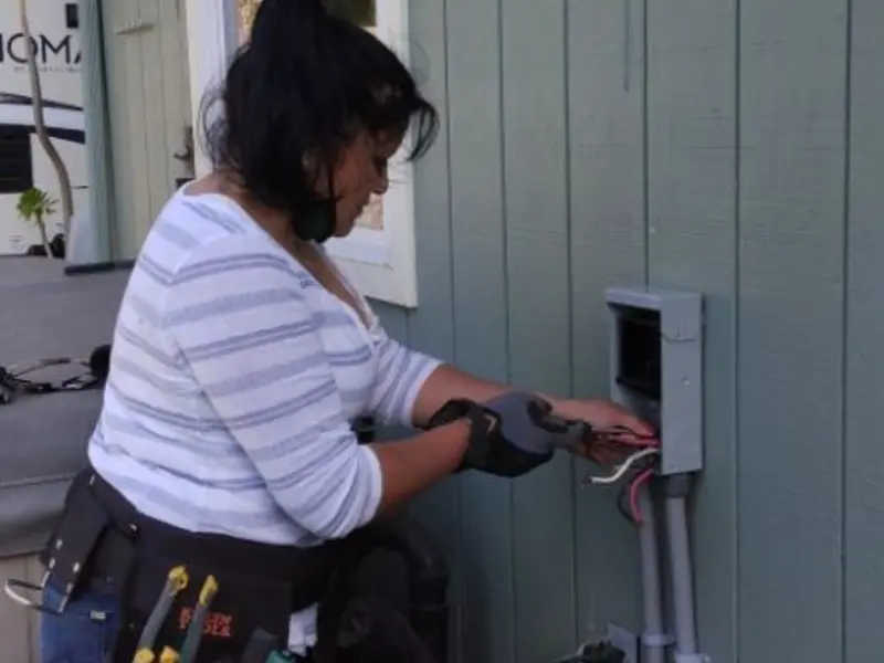 Licensed electrician wiring an exterior subpanel in Fairview